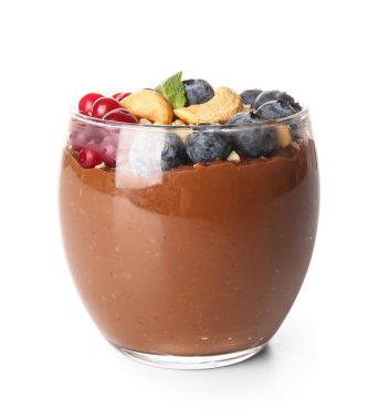 Glass of delicious chocolate pudding with fresh berries, cashew and mint isolated on white background