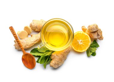 Fresh ginger roots, lemon and cup of tea isolated on white background