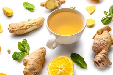 Composition with cup of tea, ginger and mint on white background
