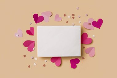 Composition with blank card, paper hearts and sprinkles on color background. Valentines Day celebration