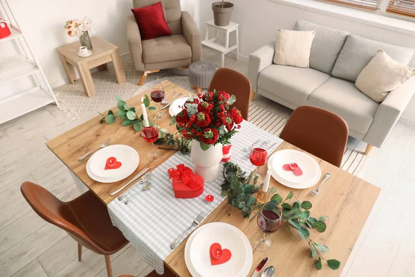 Table setting for Valentine\'s Day with beautiful flowers in dining room