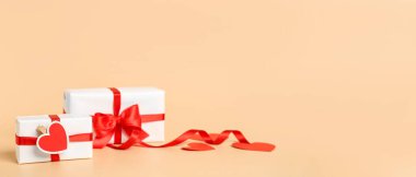Gift boxes on beige background with space for text. Valentine's Day celebration