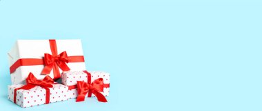 Gift boxes on light blue background with space for text. Valentine's Day celebration