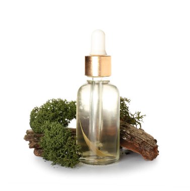 Cosmetic dropper bottle, tree bark and green moss on white background