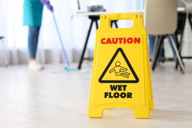 Caution sign on floor in office