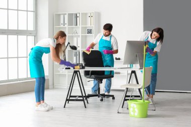 Young janitors cleaning in modern office