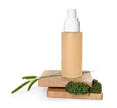 Cosmetic bottle with green moss, grass and stands on white background