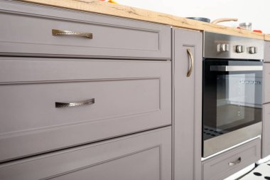 Grey counter with drawers in modern kitchen, closeup