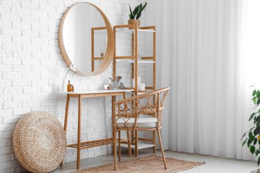 Interior of stylish makeup room with table, mirror and shelving unit