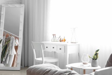 Interior of stylish dressing room with table and mirror