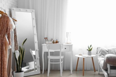 Interior of stylish dressing room with table and mirror