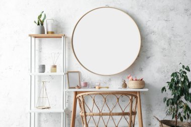 Interior of stylish makeup room with table, mirror and shelving unit
