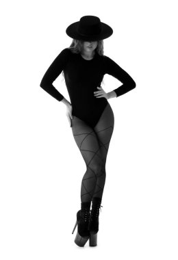 Attractive female dancer in high heels on white background