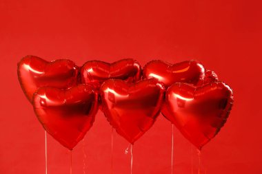 Heart shaped balloons for Valentine's Day on red background