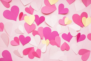 Composition with paper hearts on pink background. Valentines Day celebration