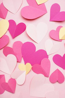 Composition with paper hearts on pink background. Valentines Day celebration