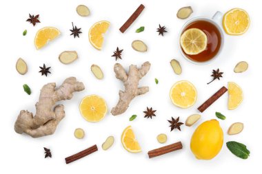 Sliced ginger root, lemon and cup of black tea isolated on white background