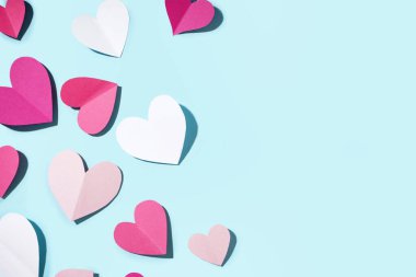 Beautiful paper hearts on blue background. Valentines Day celebration
