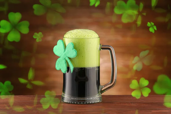 Mug of beer with clover on wooden background. St. Patrick\'s Day celebration