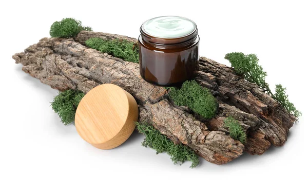 Jar of cream with tree bark and green moss on white background