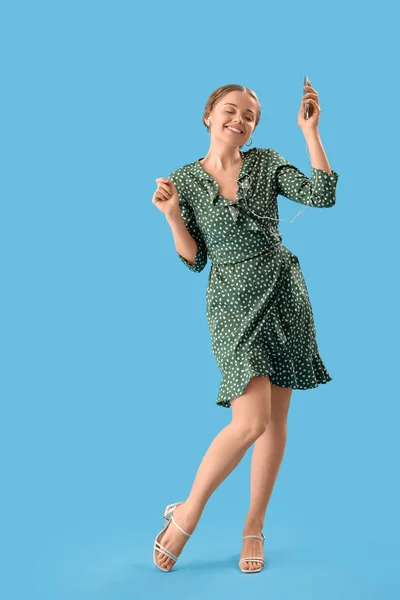 Young Woman Earphones Mobile Phone Dancing Blue Background — Stock fotografie