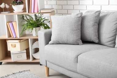 Grey sofa and shelving unit in light living room