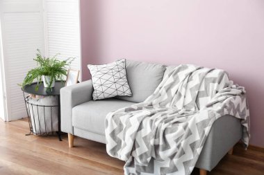 Interior of stylish living room with grey sofa and table