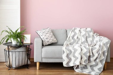 Interior of stylish living room with grey sofa and table