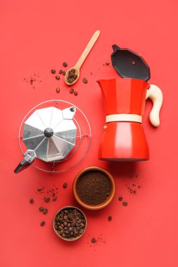 Composition with geyser coffee maker and beans on red background