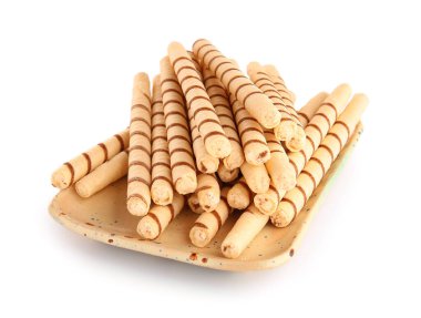 Board with tasty wafer rolls isolated on white background