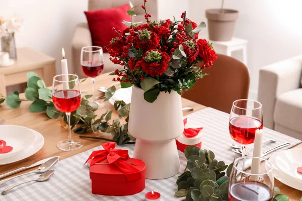 Table setting for Valentine\'s Day with beautiful flowers in dining room, closeup
