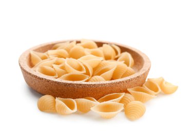 Plate of raw conchiglioni pasta on white background