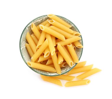 Bowl of raw penne pasta on white background