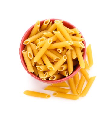 Bowl of raw penne pasta on white background