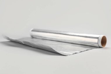 Roll of aluminium foil on grey background