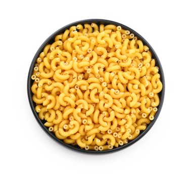 Plate of raw elbow pasta isolated on white background