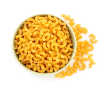 Bowl of uncooked elbow pasta on white background