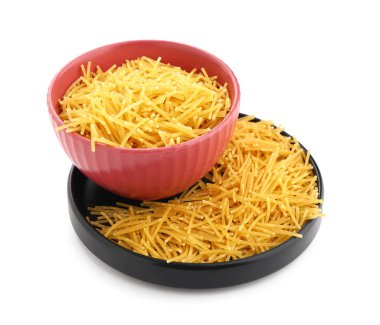 Bowl and plate of raw vermicelli pasta isolated on white background