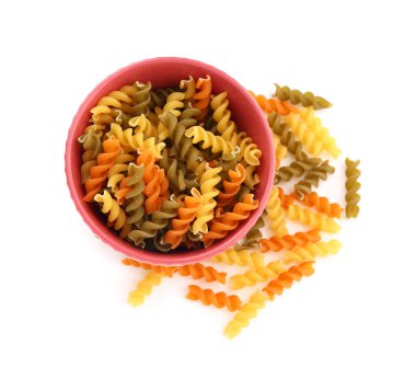 Bowl of uncooked fusilli pasta on white background