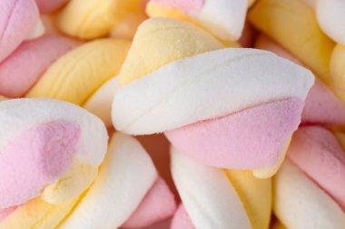 Tasty twisted marshmallows as background, closeup