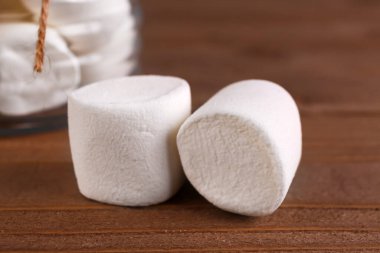 Delicious marshmallows on brown wooden table