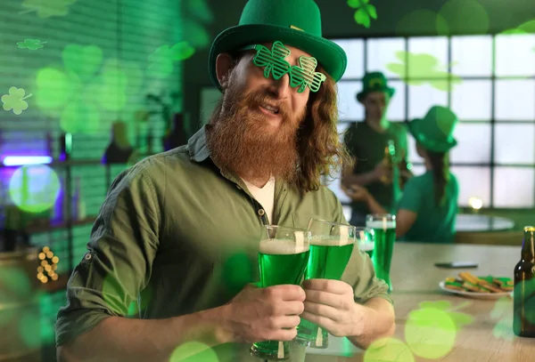 Funny bearded man with glasses of beer celebrating St. Patrick\'s Day in pub
