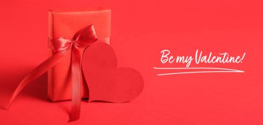 Greeting card for Valentine's Day with gift and heart on red background