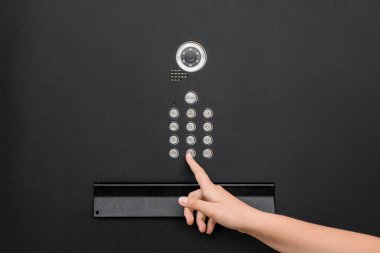 Child using intercom outdoors, closeup
