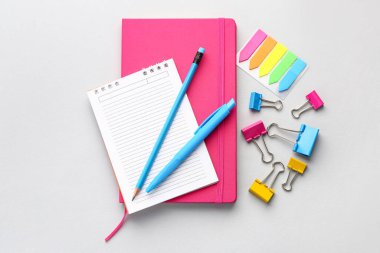 Set of stationery with notebooks on light background