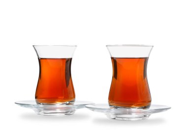 Glass cups of Turkish tea on white background