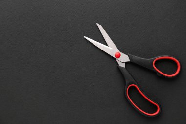Office scissors on dark background