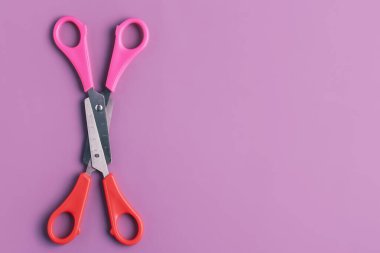 Colorful scissors on lilac background