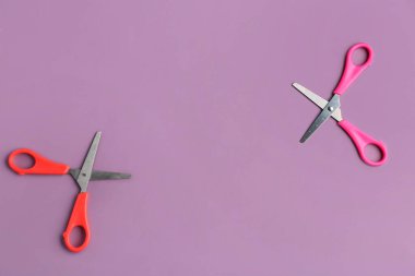 Colorful scissors on lilac background