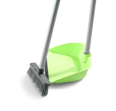 Cleaning broom with green dustpan on white background